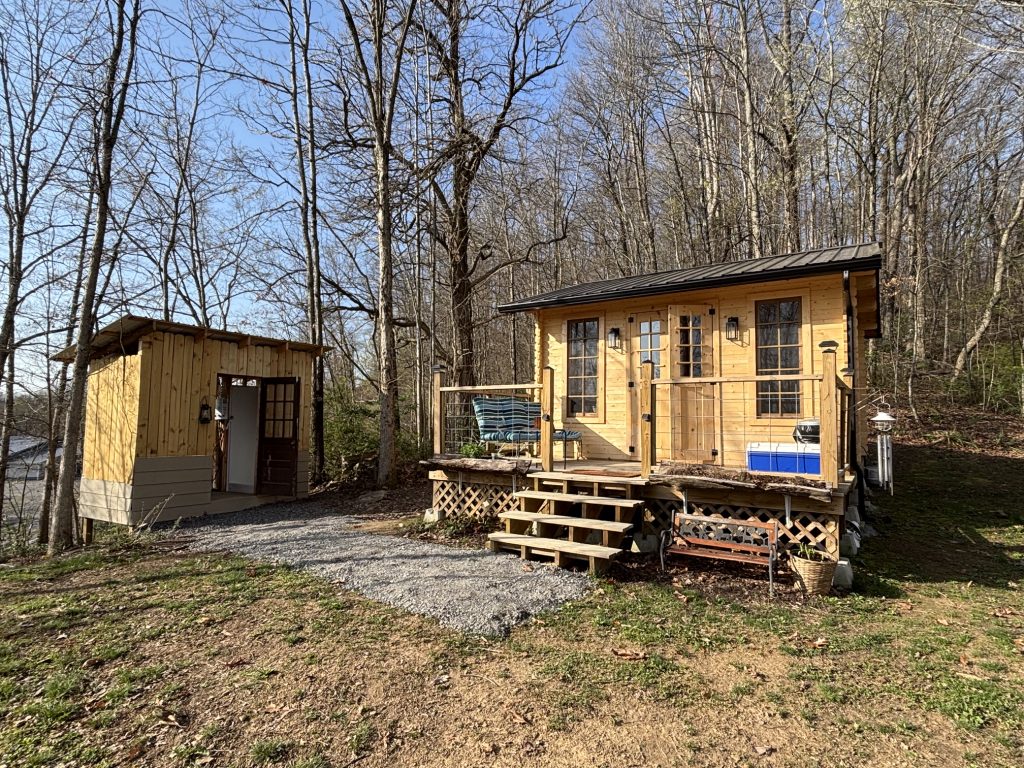 hilltop sunrise urban bunkie-style cabin private hot outdoor shower queen bed flush toilet new river gorge bridge Fayette county Fayetteville oak hill hilltop WV West Virginia side view full resolution includes shower house with open door