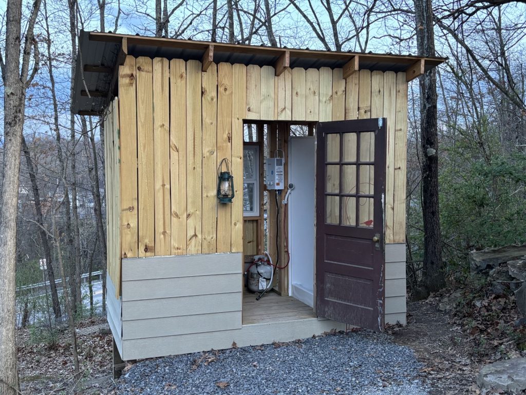 hilltop sunrise urban camping bunkie-style cabin with private hot outdoor shower sink flush toilet new river gorge bridge Fayette county Fayetteville oak hill hilltop WV West Virginia