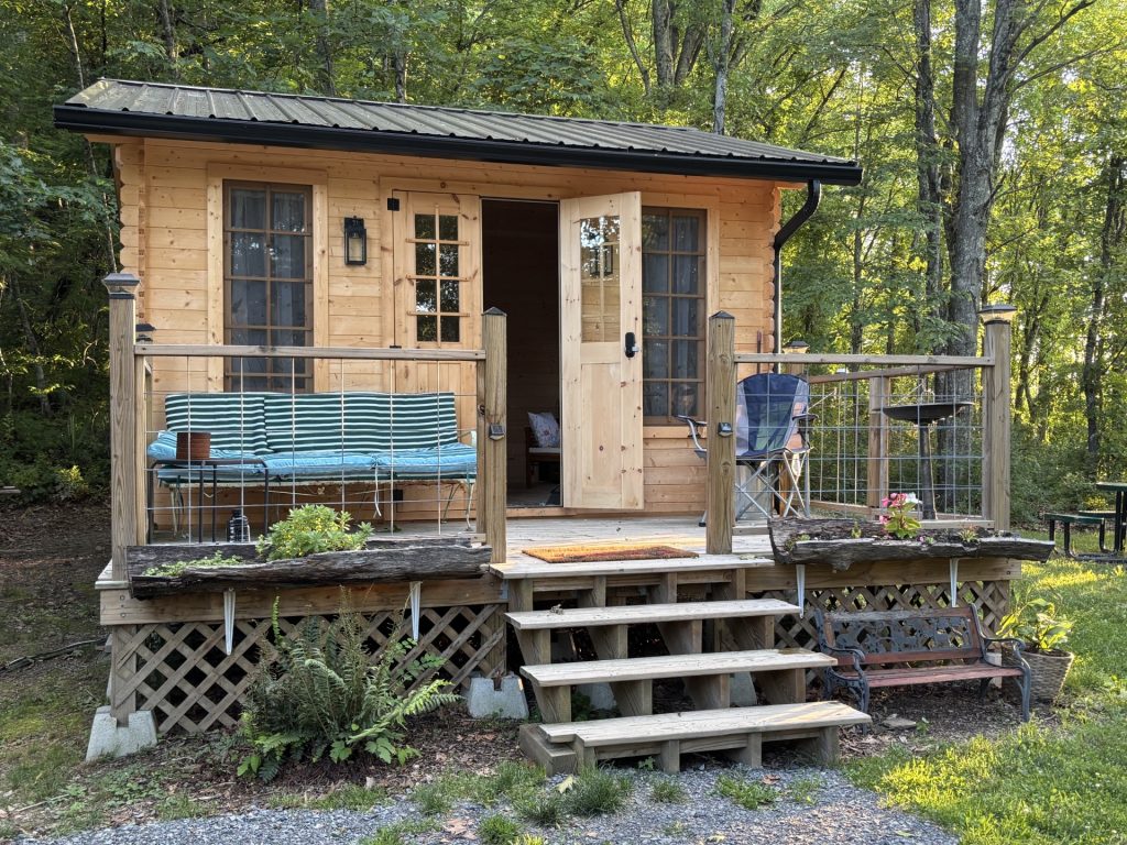 hilltop sunrise urban bunkie-style cabin private hot outdoor shower queen bed flush toilet new river gorge national park and preserve bridge Fayette county Fayetteville oak hill hilltop WV West Virginia side view full resolution includes shower house with open door