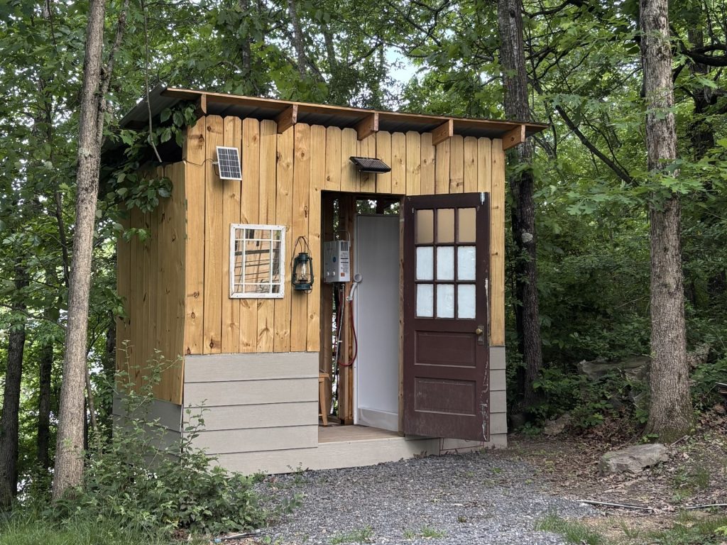 hilltop sunrise urban camping bunkie-style cabin with private hot outdoor shower sink flush toilet new river gorge national park and preserve bridge Fayette county Fayetteville oak hill hilltop WV West Virginia June 2026